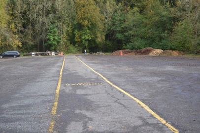 Gravel parking lot for the sports fields - yellow centerlines lead to the Trillium natural surface trail